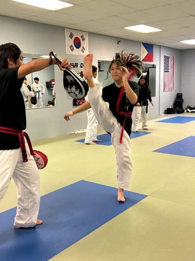 Samantha Bautista demonstrating a Taekwondo kick