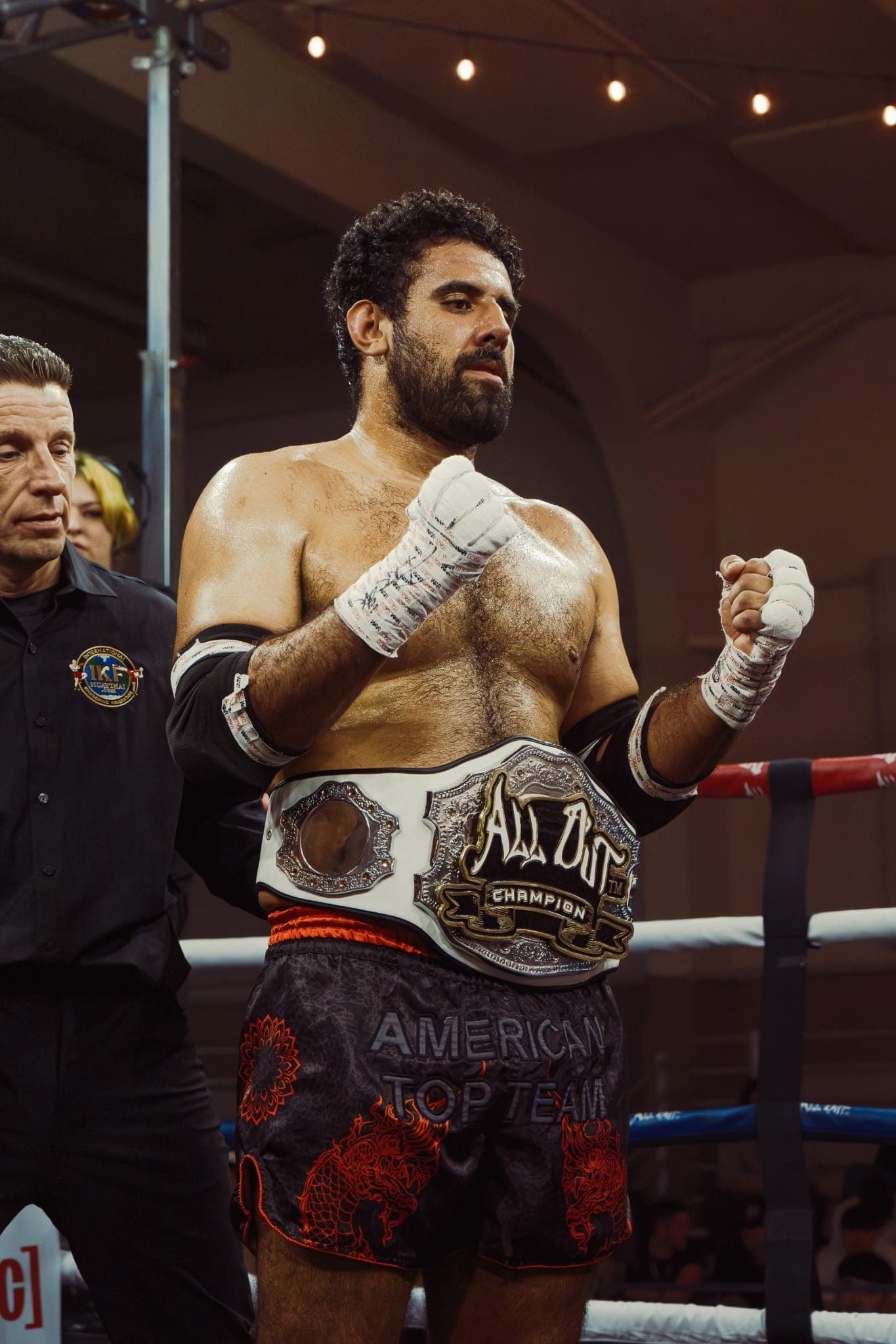 Christian Orellana, Muay Thai instructor at Team Cama, with a championship belt in the ring