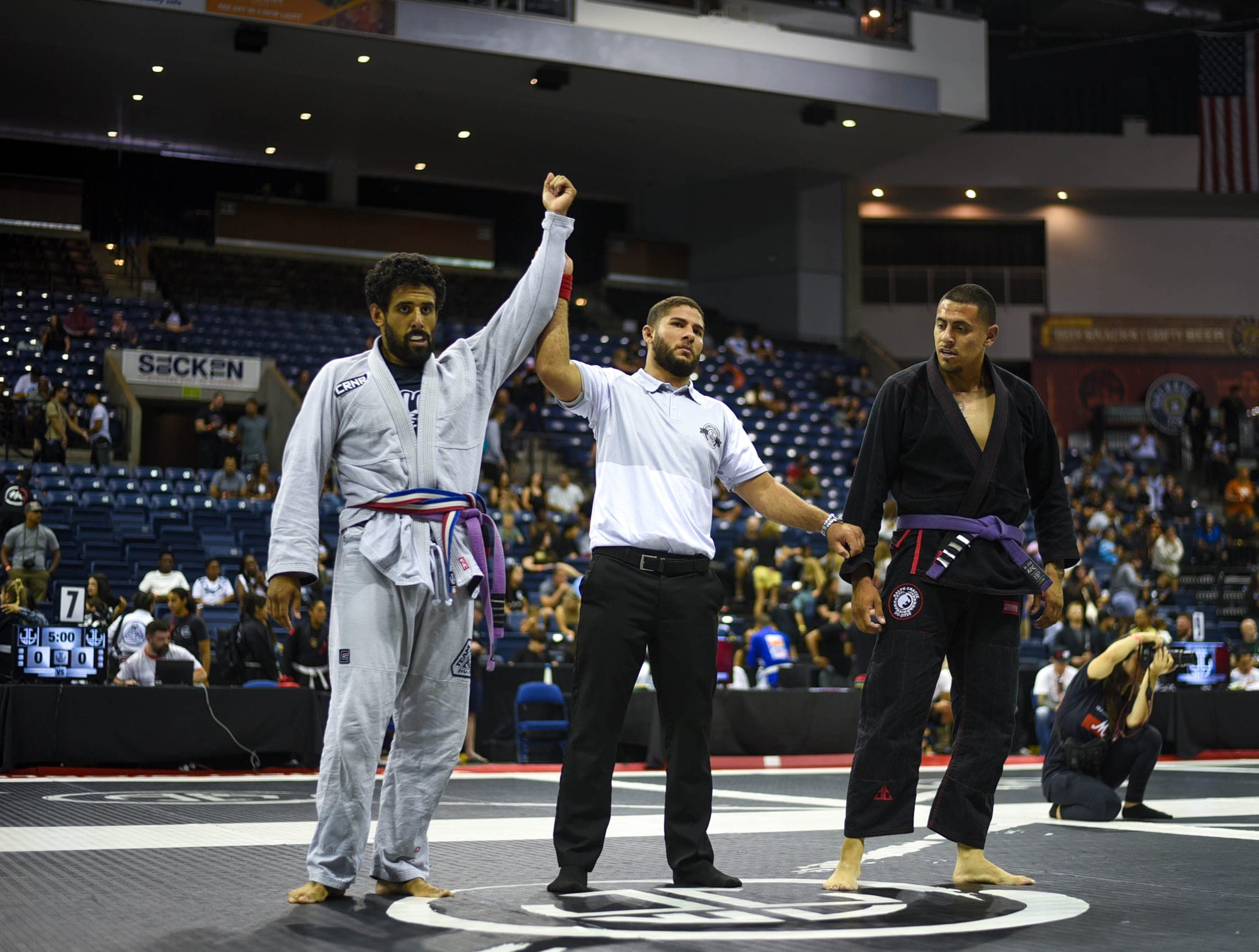 A Team Cama competitor celebrating on the mat