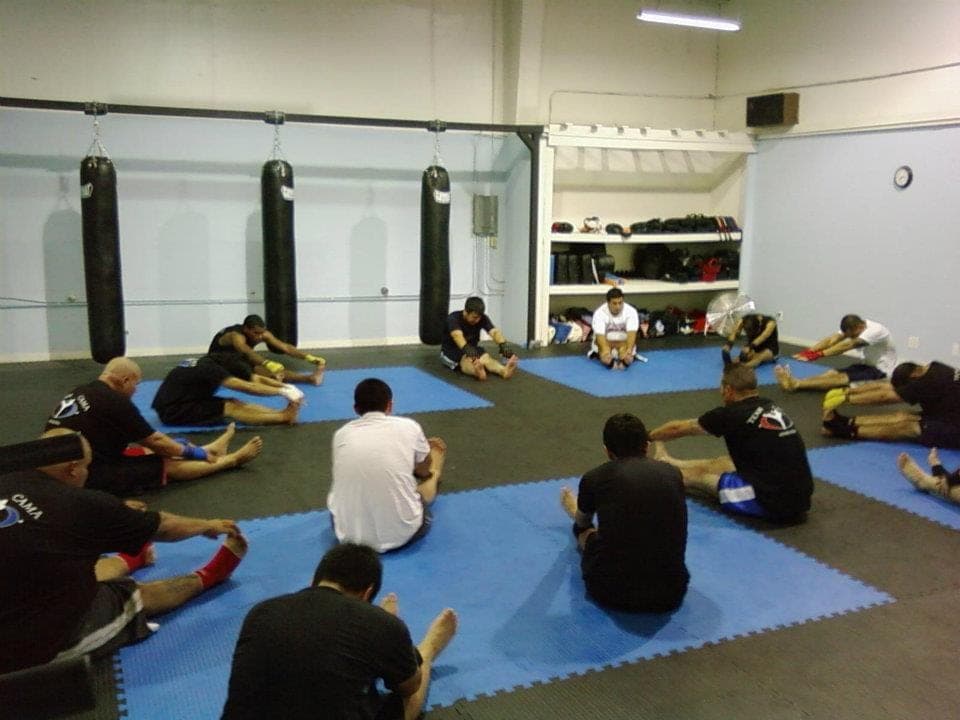 Students seated on the mats inside the San Juan Avenue garage, 2011